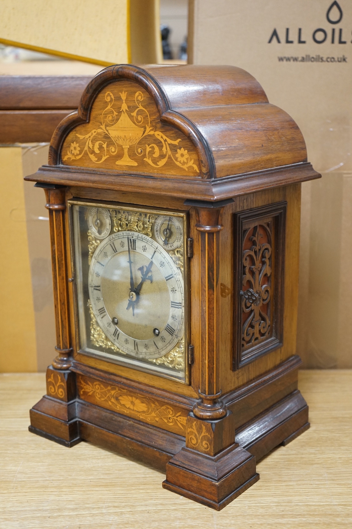 A rosewood mantel clock with French silk suspension movement, together with an Edwardian marquetry bracket clock signed to the dial S.Smith and son, Strand, London with a two train German movement striking on two coiled